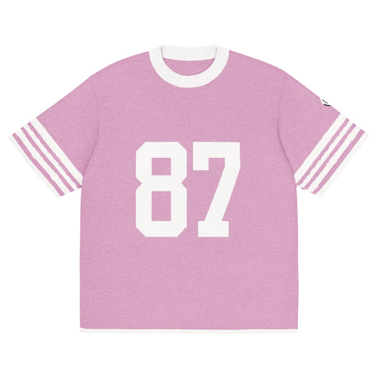Front of Pink knitted t-shirt with number 87 and stripes on sleeves in white