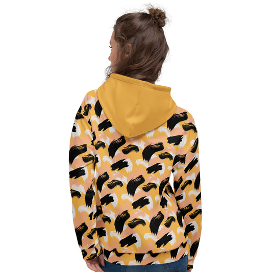 Back of woman wearing a yellow hoodie with black abstract pattern 