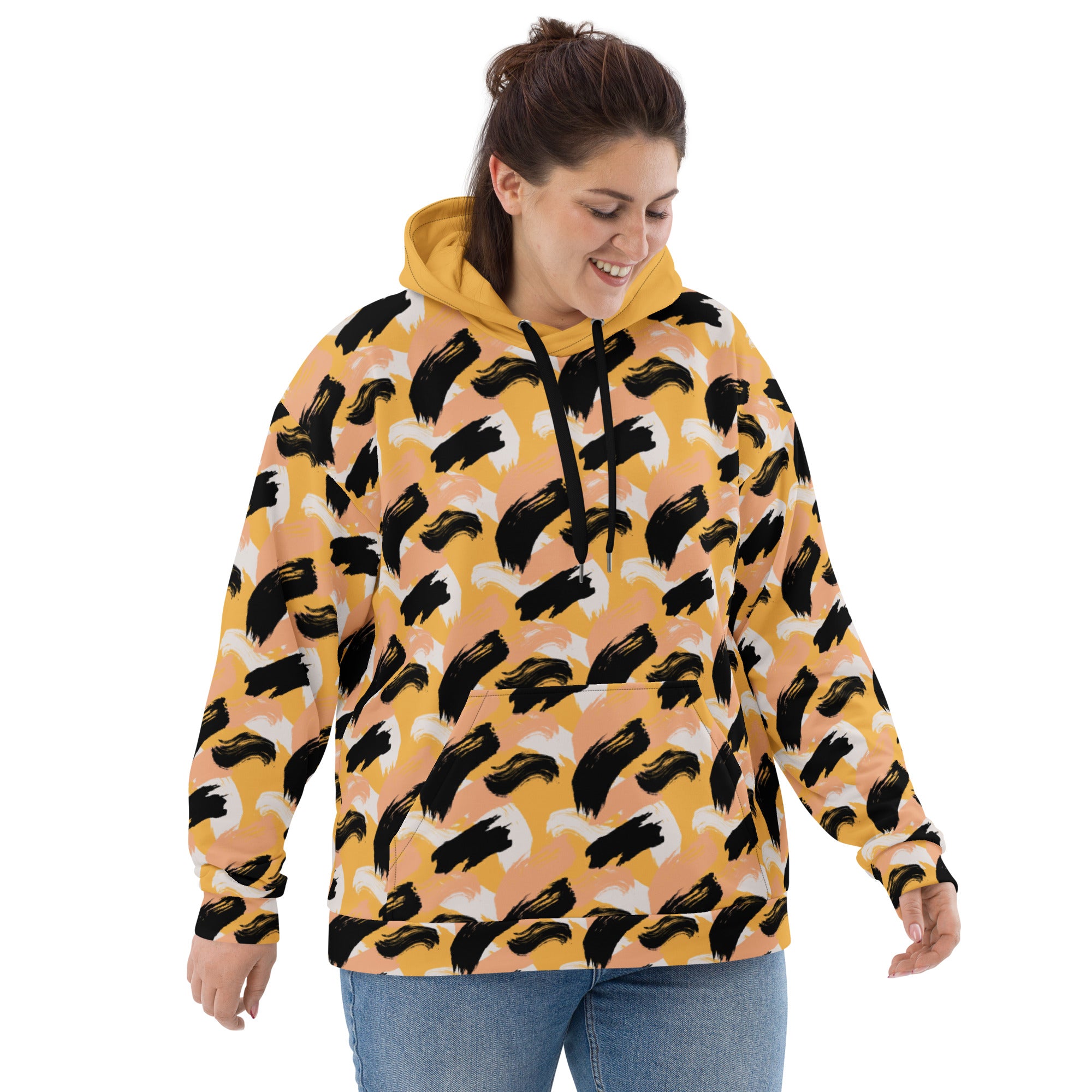 Front of Woman wearing a yellow hoodie with abstract pattern 