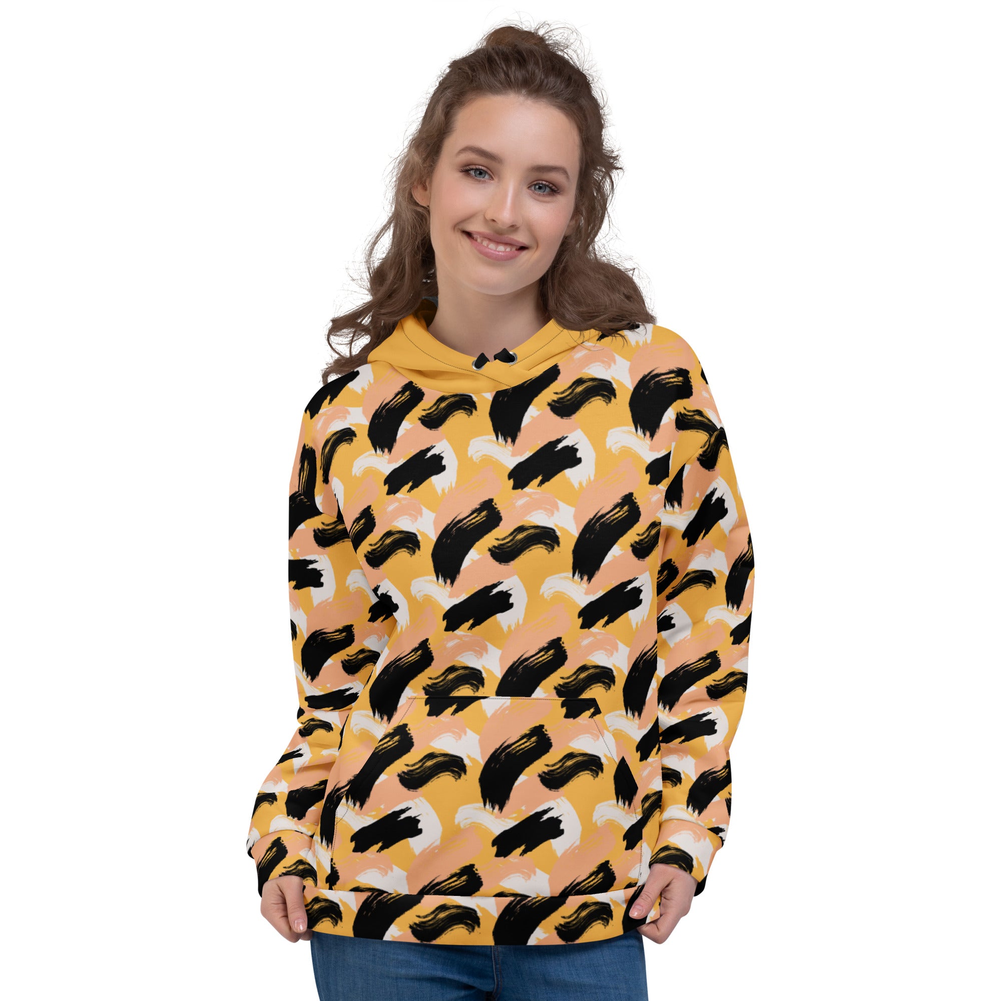 Front of Woman wearing a yellow hoodie with black abstract pattern