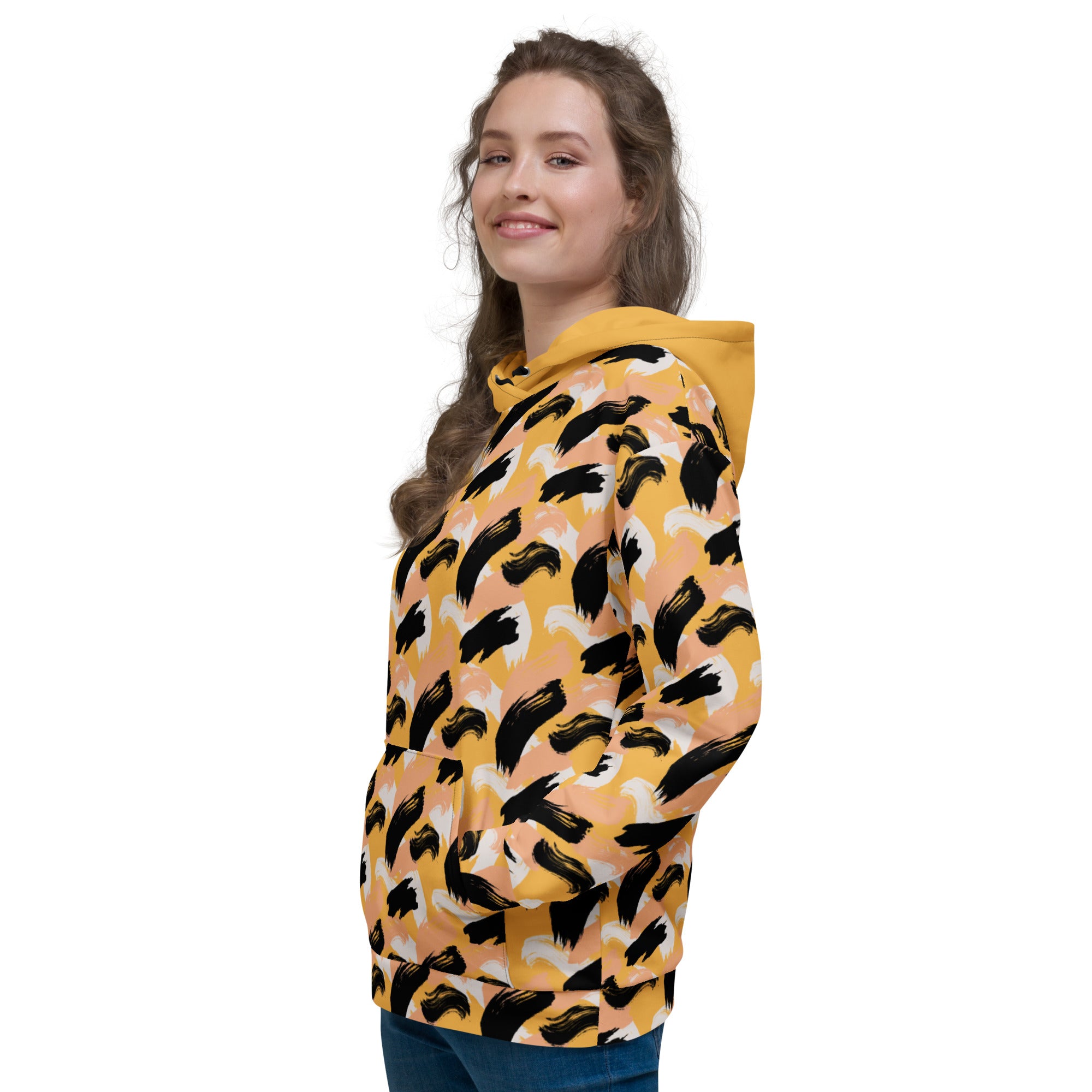 Left side of Woman wearing a yellow hoodie with black abstract pattern 