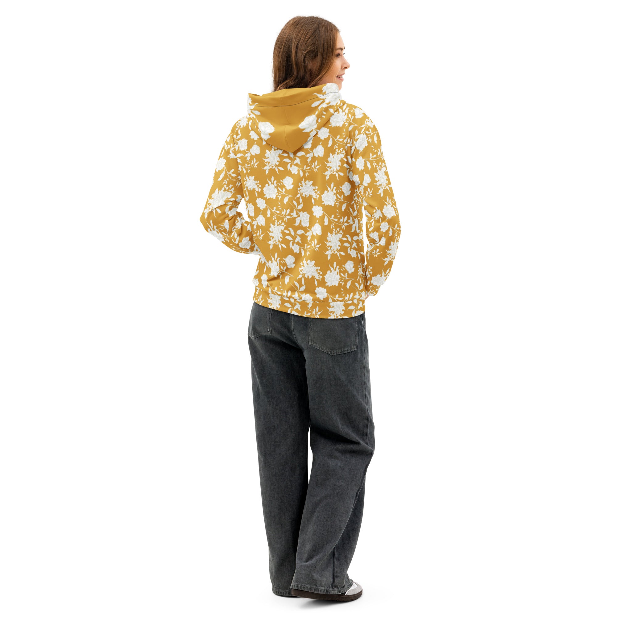 Back of woman wearing a yellow floral hoodie and gray black pants 