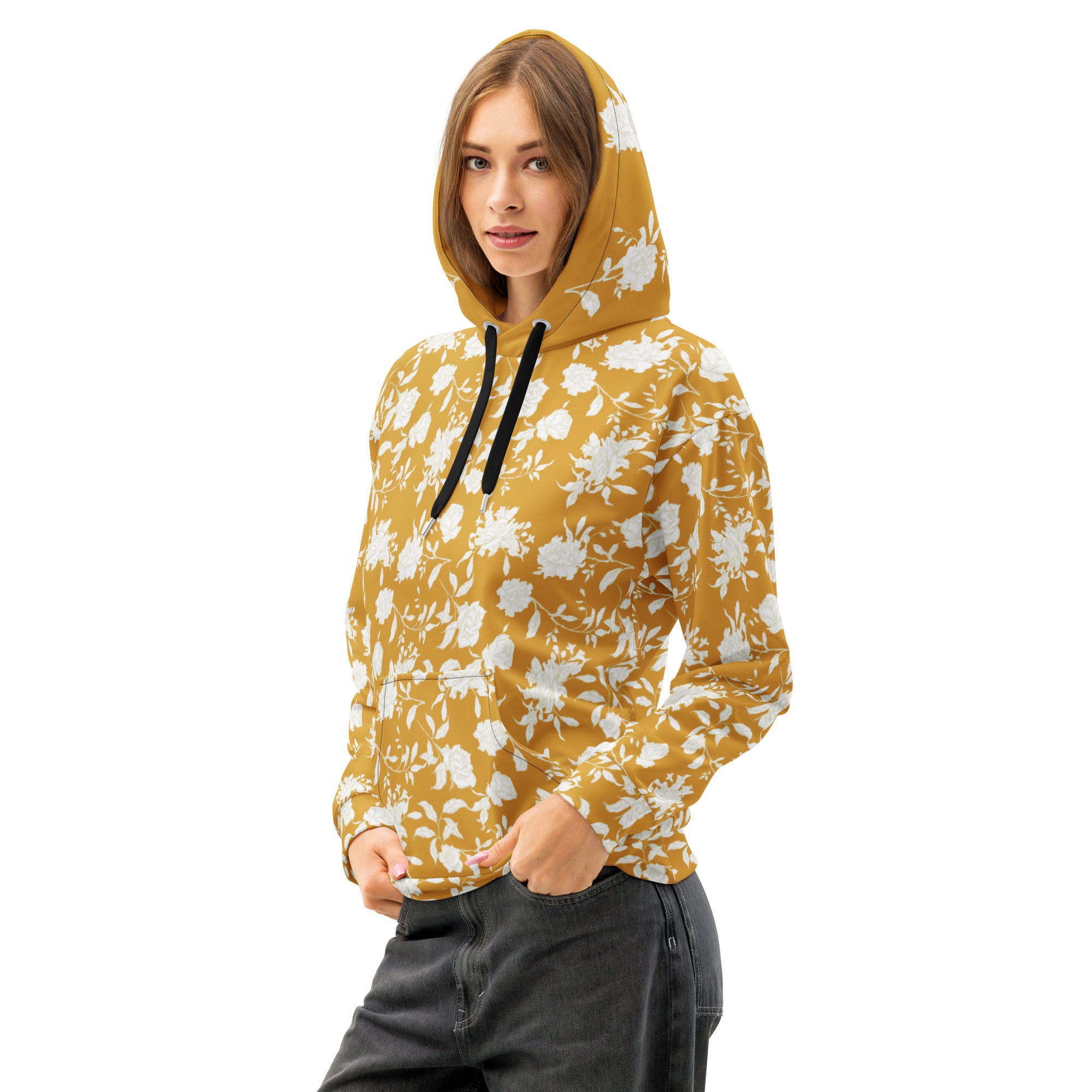 Front left of woman wearing a yellow floral hoodie  with hands in pockets