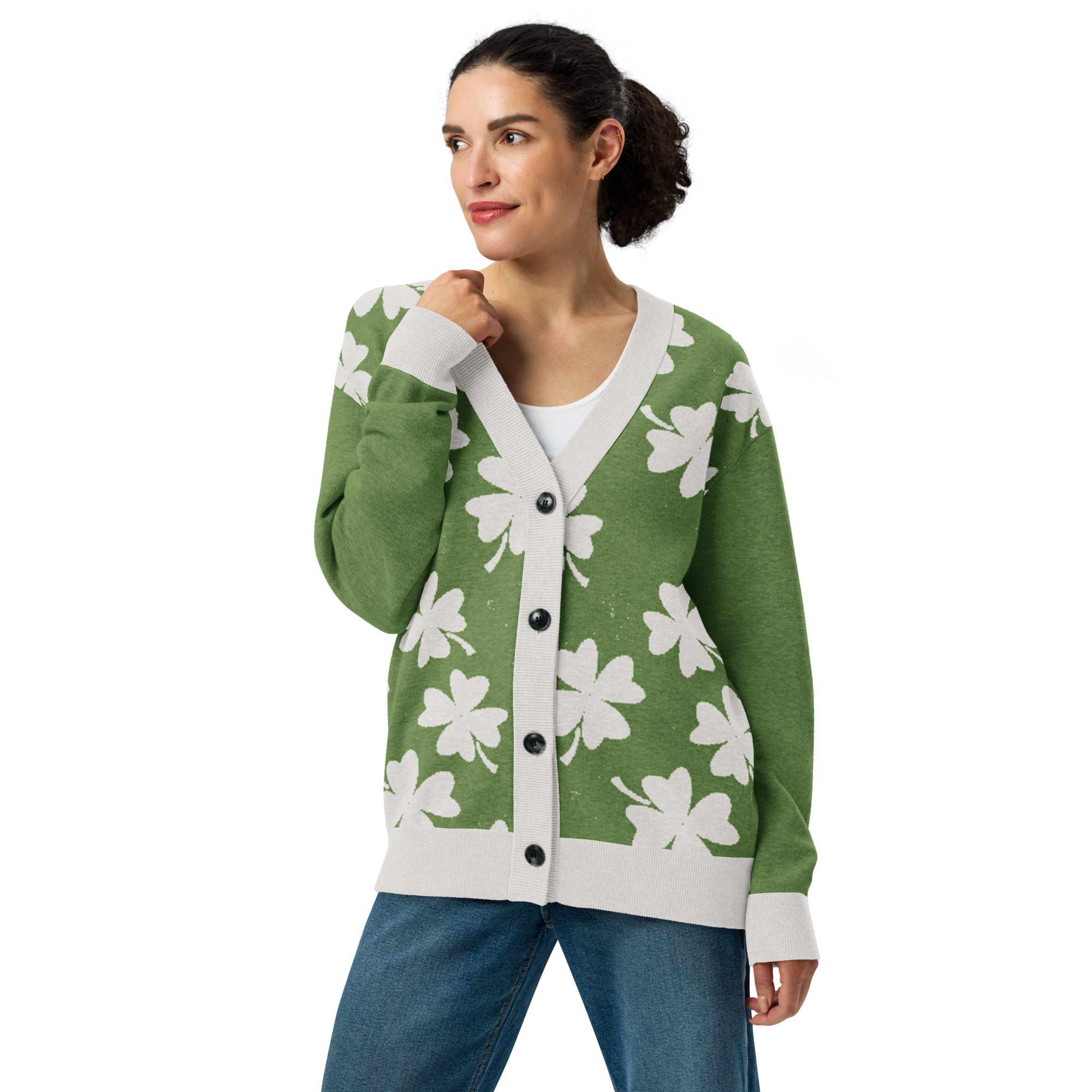 Front of Woman wearing a distressed green cardigan with white four-leaf clover pattern, buttoned up, looking to the right with arm bent upward 