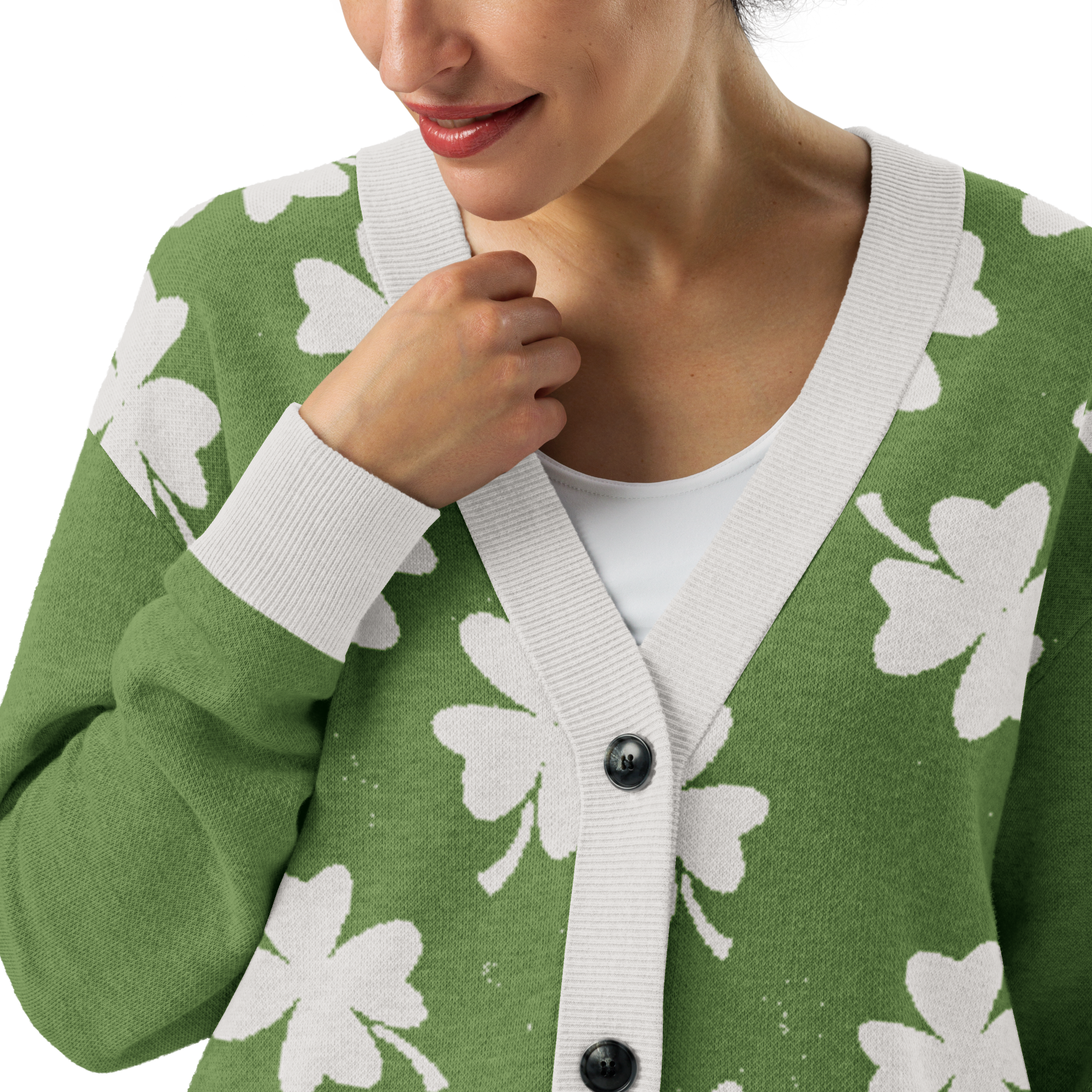 Close up of distressed Green cardigan with white four-leaf clover pattern worn by a woman 