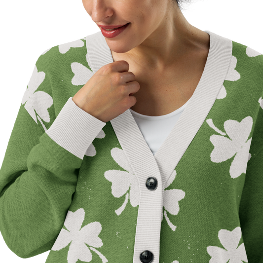 Close up of distressed Green cardigan with white four-leaf clover pattern worn by a woman 