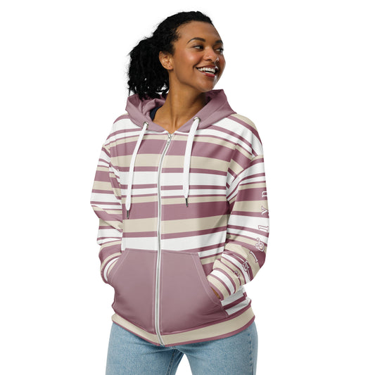 Front left of Woman wearing a striped hoodie that is zipped up with her hands in the front pockets. the left sleeve features white text with a pink outline "carl & lyn".