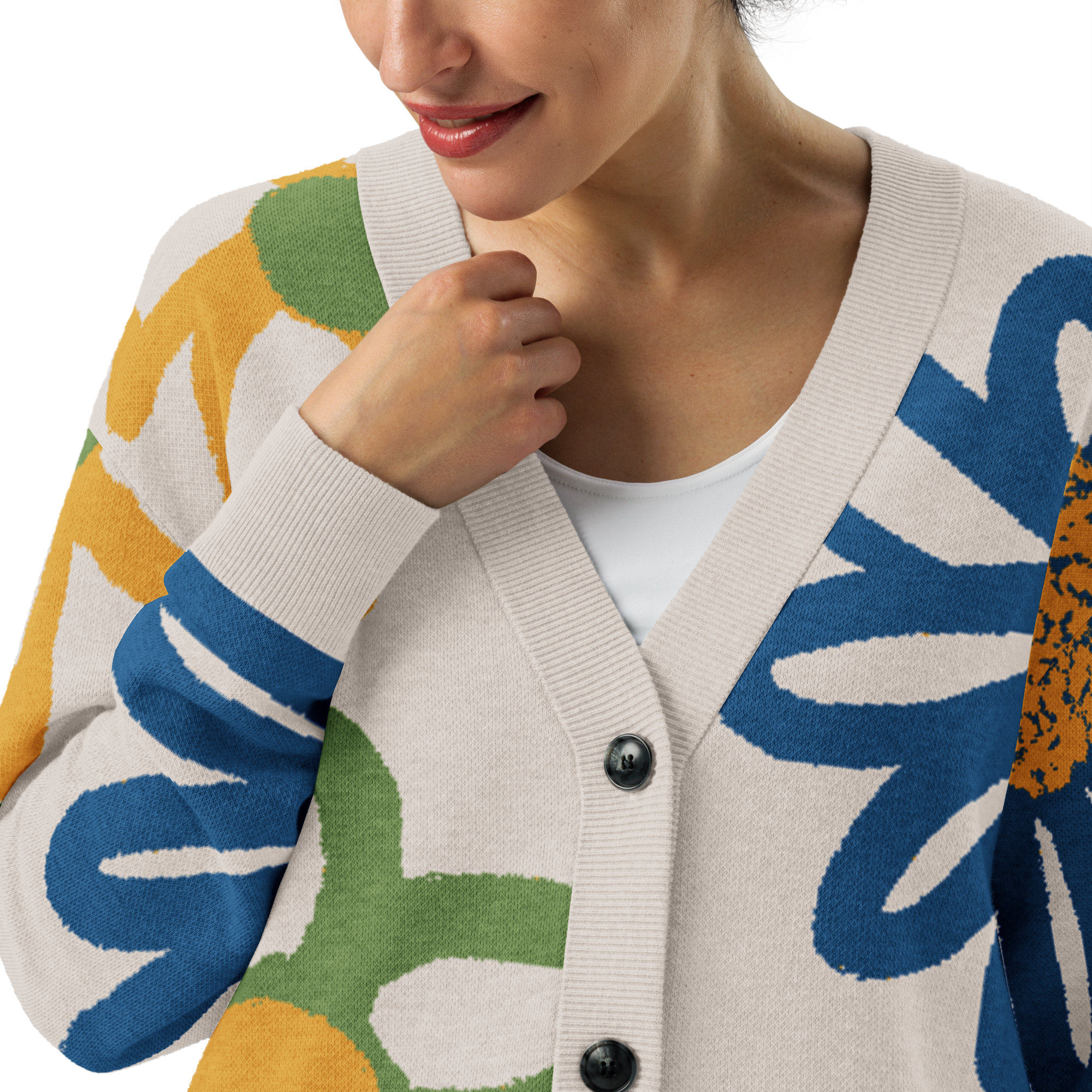 Front Close-up of a woman wearing a white tee under a colorful cardigan with floral patterns , with button front closure and right arm bent toward collar