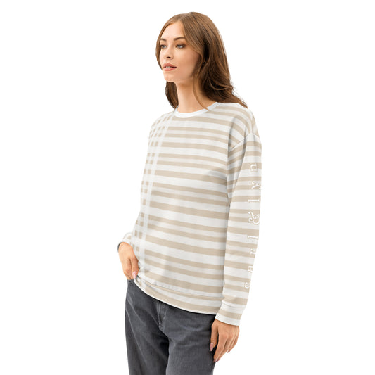 Front left of Woman wearing a Tan and white striped sweater with the Carl & Lyn logo on the left sleeve, checkered pattern on right side of garment
