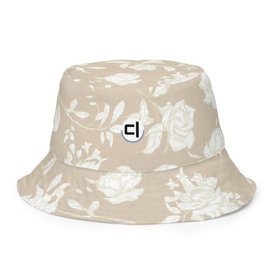 Inside Front Tan bucket hat with white floral pattern and a logo 