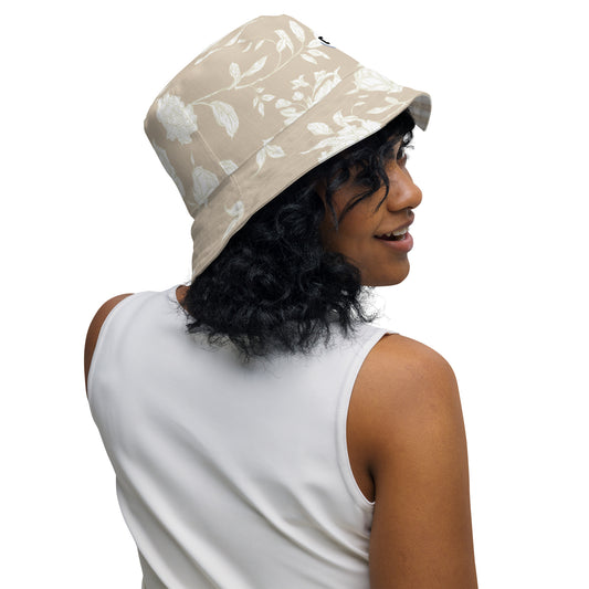 Inside Right view of Woman wearing a tan bucket hat with floral patterns looking right smiling