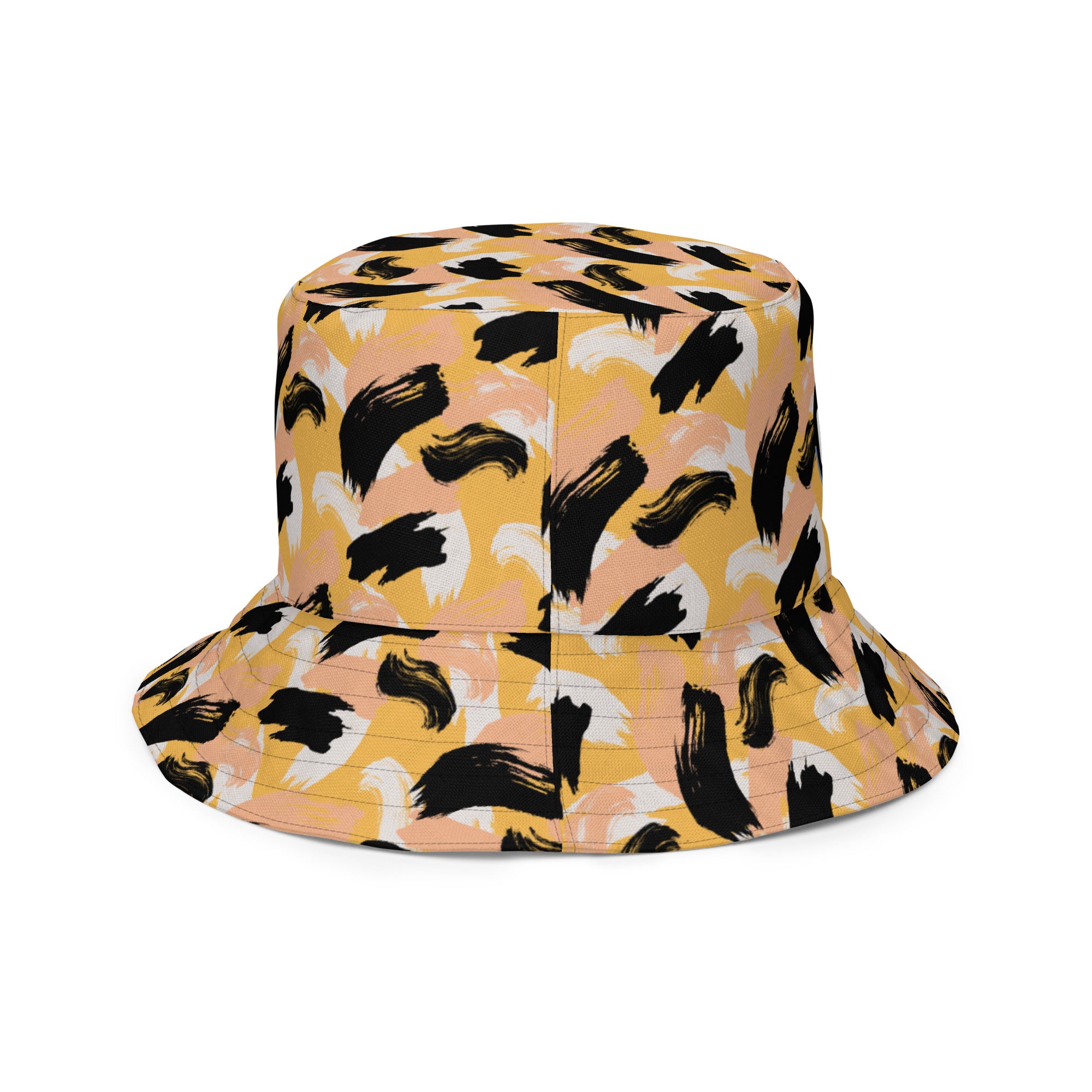 Right side of Bucket hat with black abstract pattern of paint strokes that resemble cheetah color combination with logo appearing on front (right side of image)