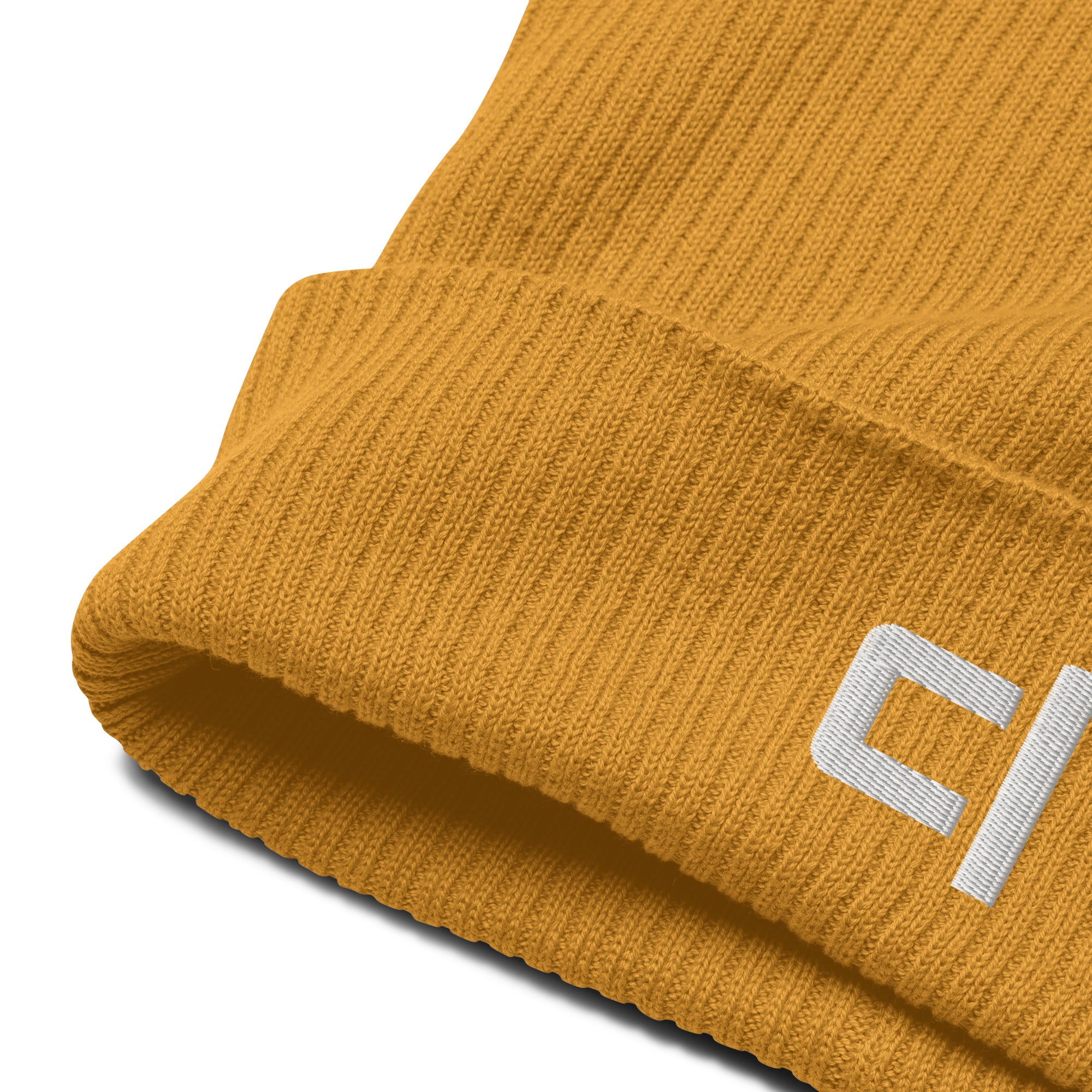 C&L Signature Organic Ribbed Beanie Beanie by Carl & Lyn mustard zoomed in fabric detail of front right cuff of beanie including embroidered white brand logo 