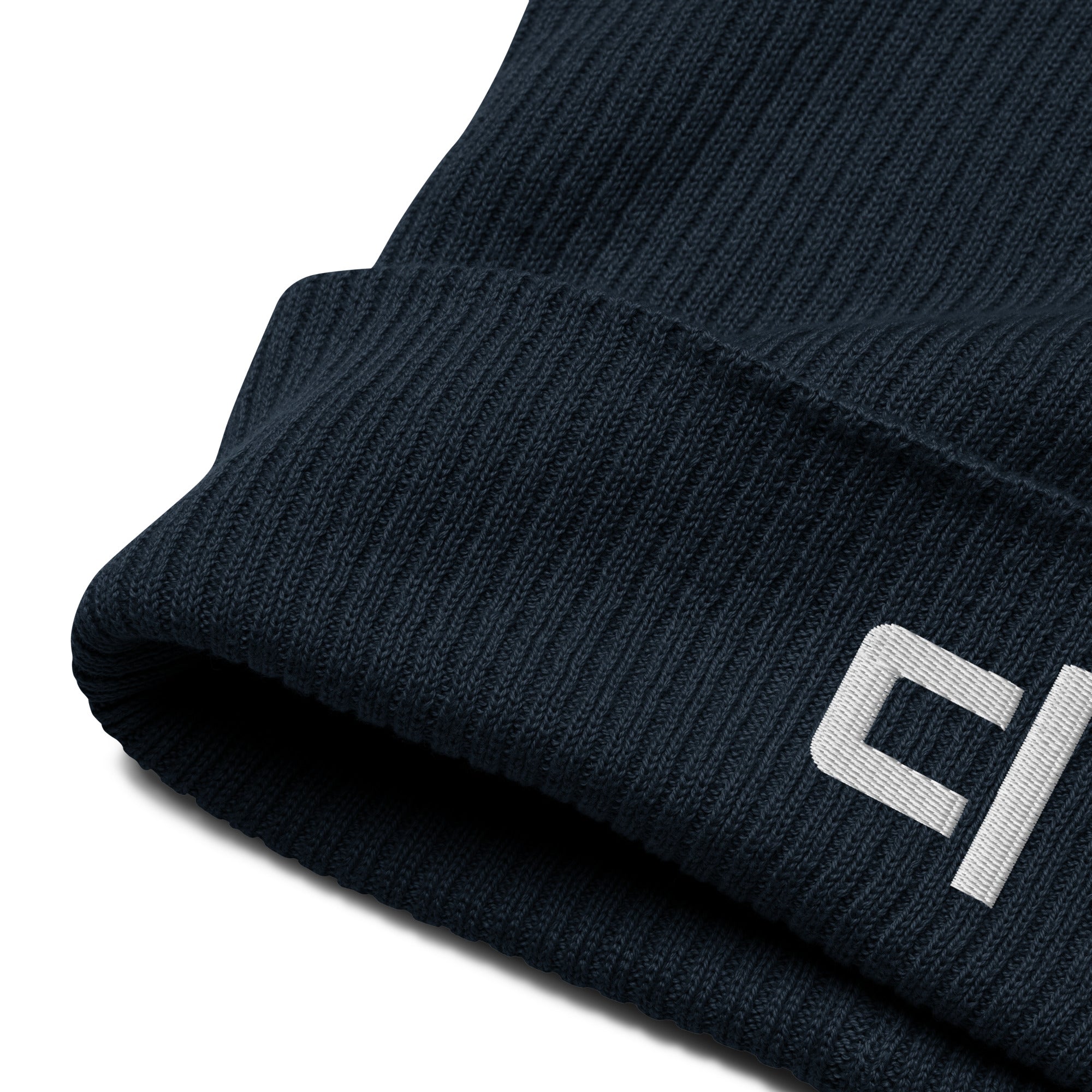 C&L Signature Organic Ribbed Beanie Beanie by Carl & Lyn deep navy zoomed in fabric detail of front right cuff of beanie including embroidered white brand logo 