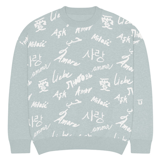 Front of light green (mist) colored knitted sweatshirt with white (cream) text pattern of the word "love" translated in various languages