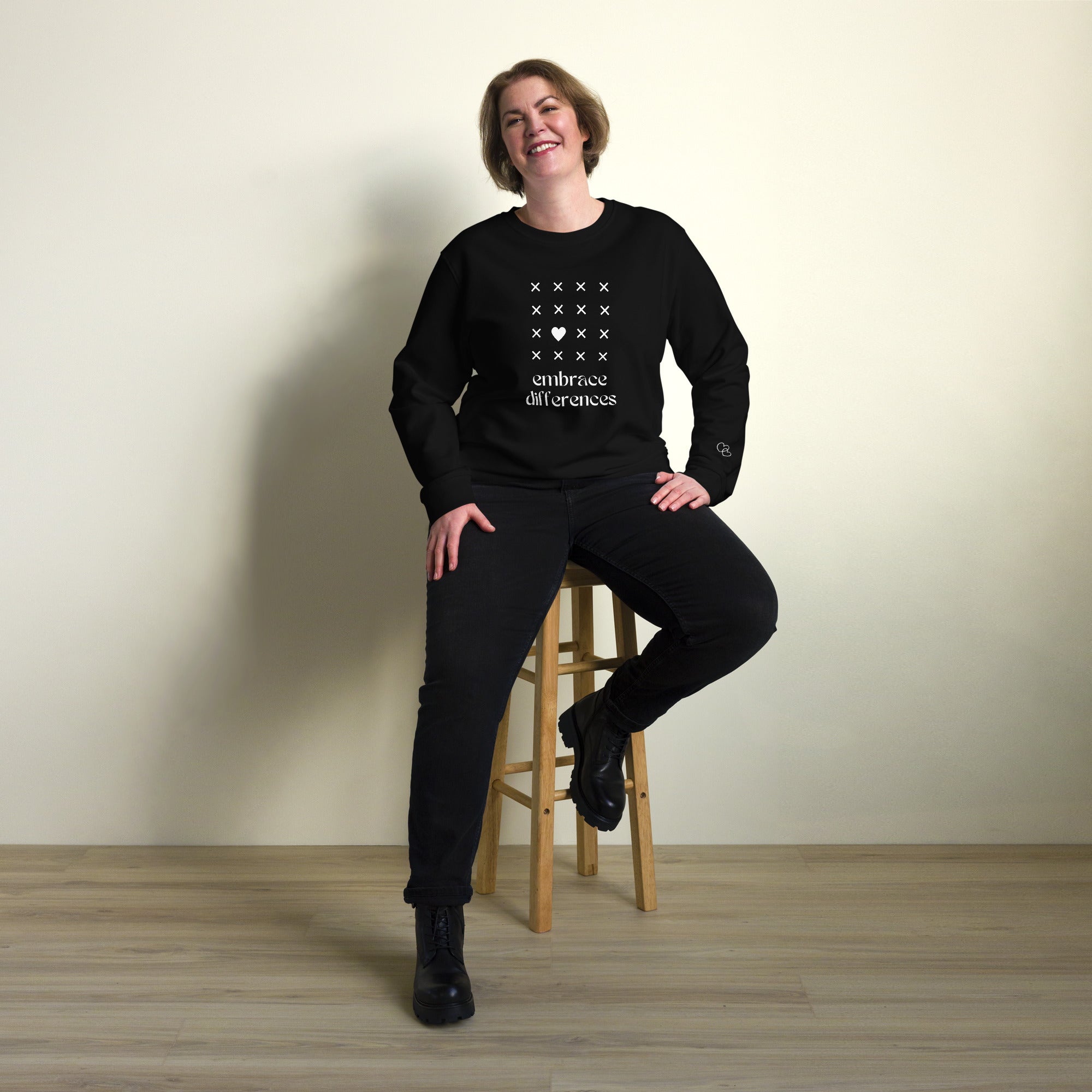 Embrace differences - Eco Sweatshirt Sweatshirt by Carl & Lyn black front person sitting
