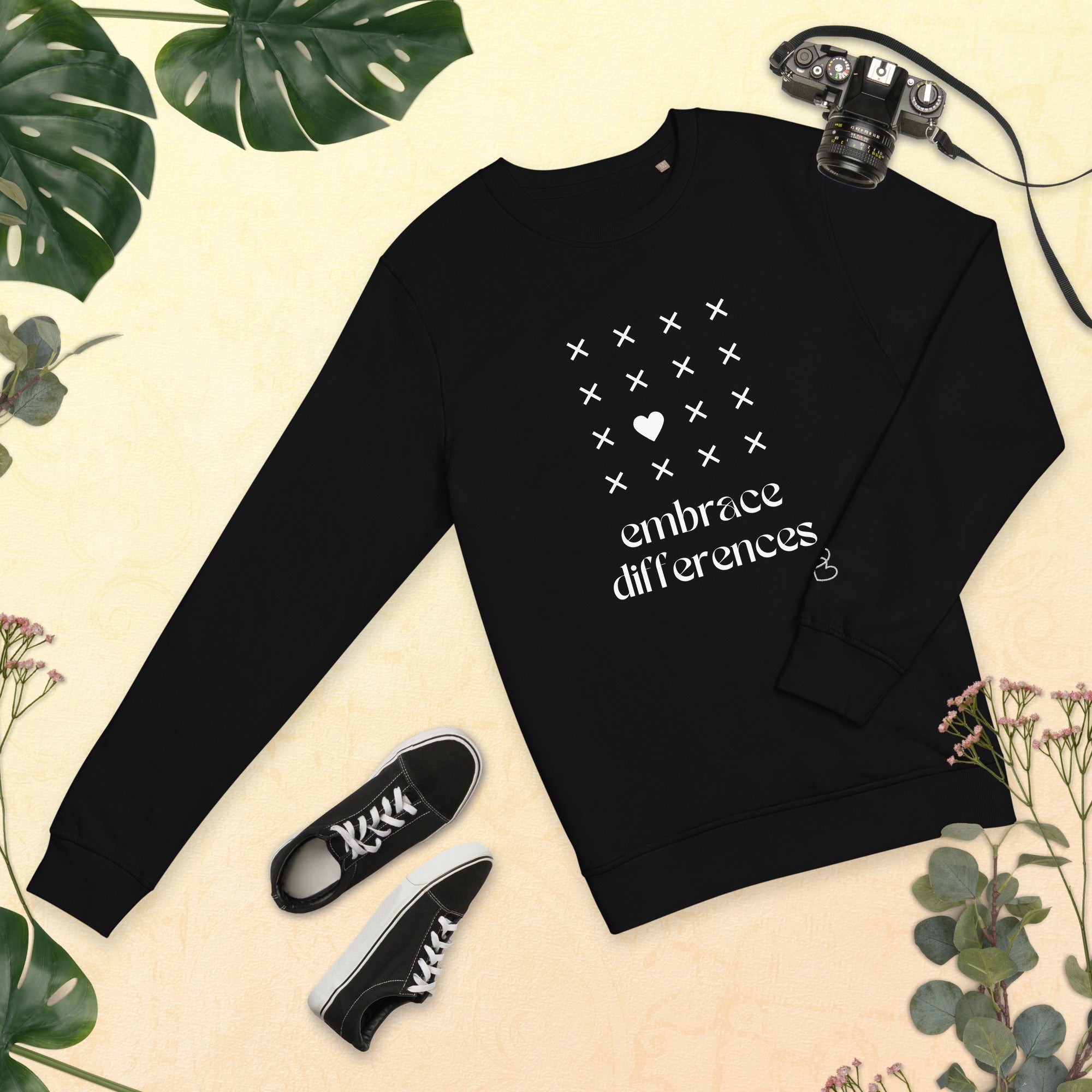 Black Embrace differences - Eco Sweatshirt Sweatshirt by Carl & Lyn black front flat view with greenery border