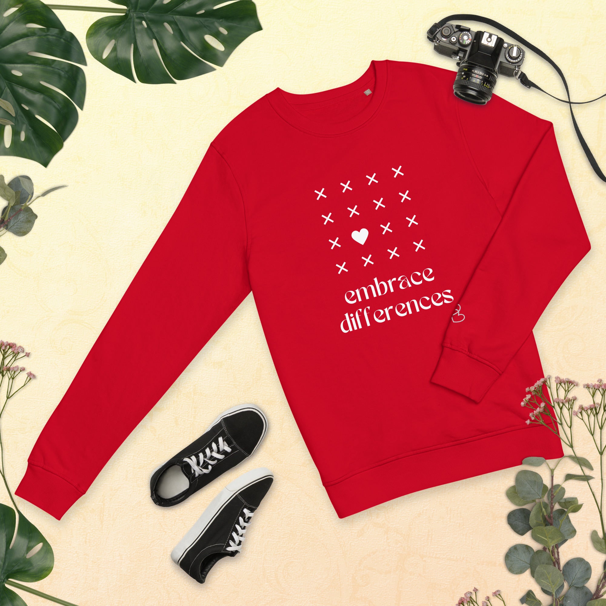 Embrace differences - Eco Sweatshirt Sweatshirt by Carl & Lyn red front flat view with greenery border